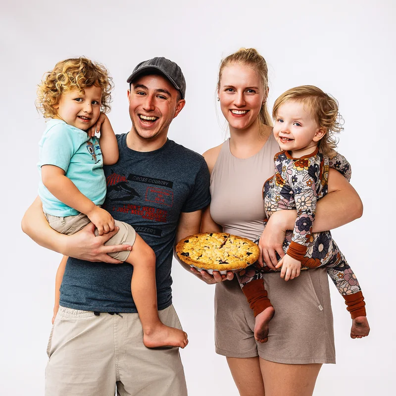 Four people posing together with an A Third Slice pie